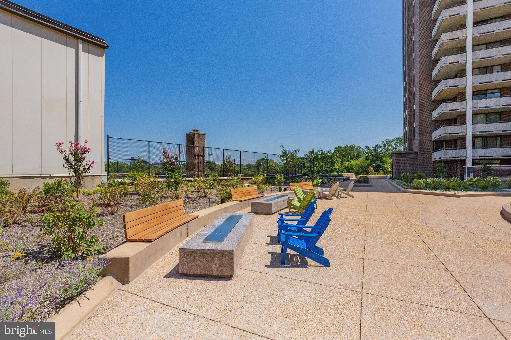 1800 Old Meadow Road, Unit 302 McLean, VA 22102 - Photo 28 of 35 a swimming pool with outdoor seating and city view