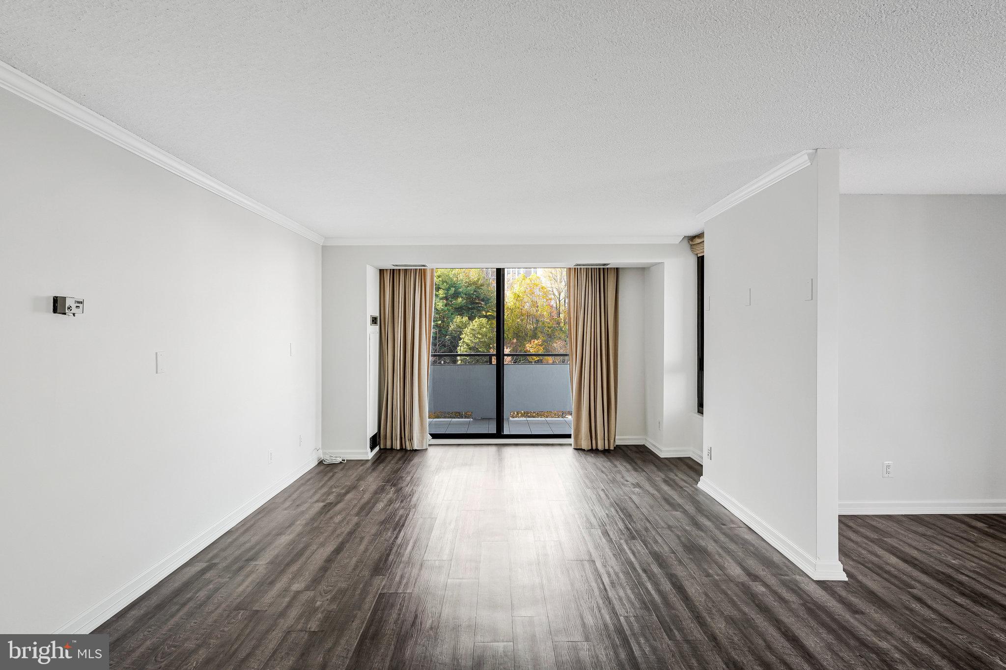 1800 Old Meadow Road, Unit 302 McLean, VA 22102 - Photo 4 of 35 an empty room with wooden floor and windows