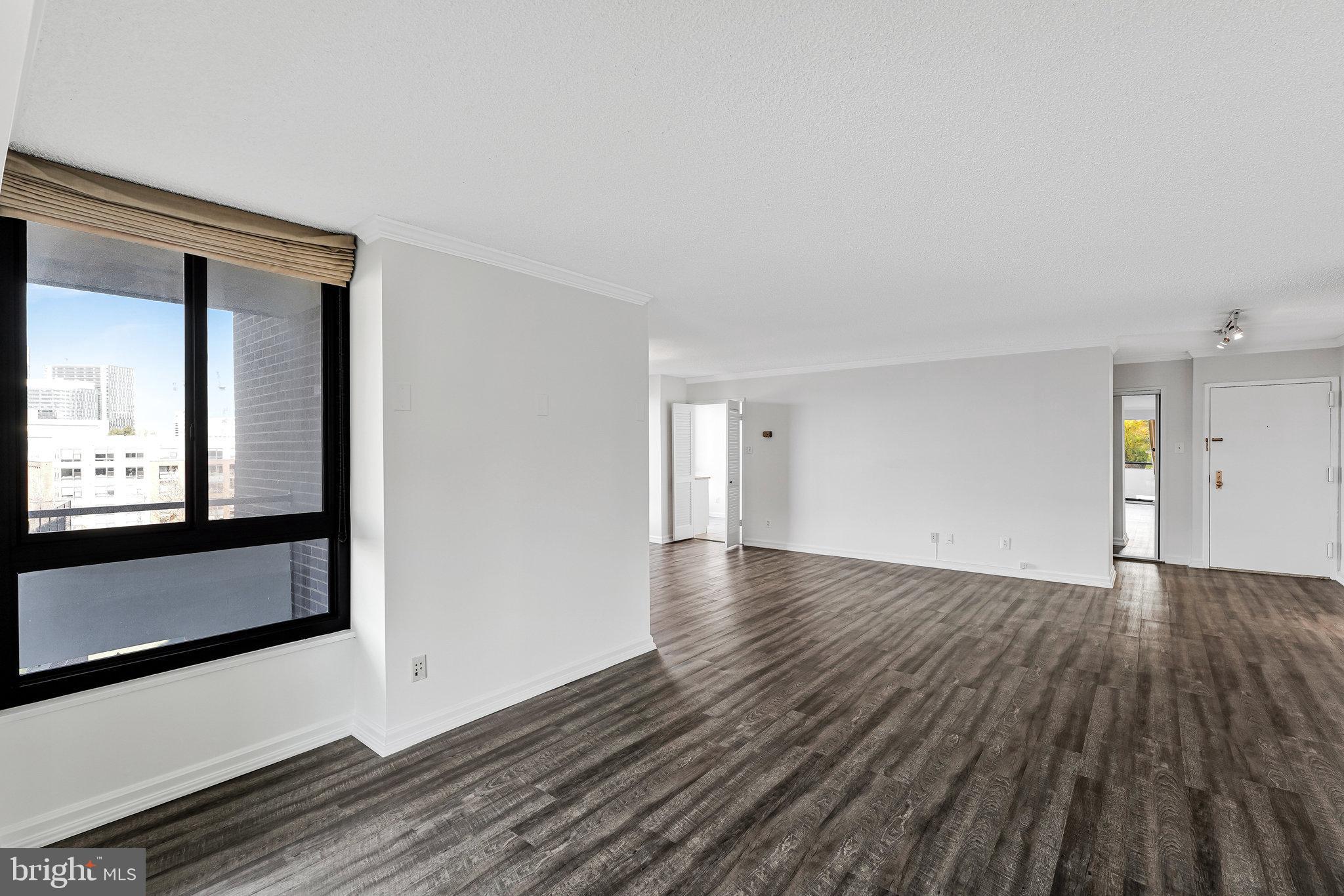 1800 Old Meadow Road, Unit 302 McLean, VA 22102 - Photo 6 of 35 a view of an empty room with wooden floor and a window