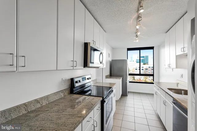 a kitchen with a stove a sink and a refrigerator