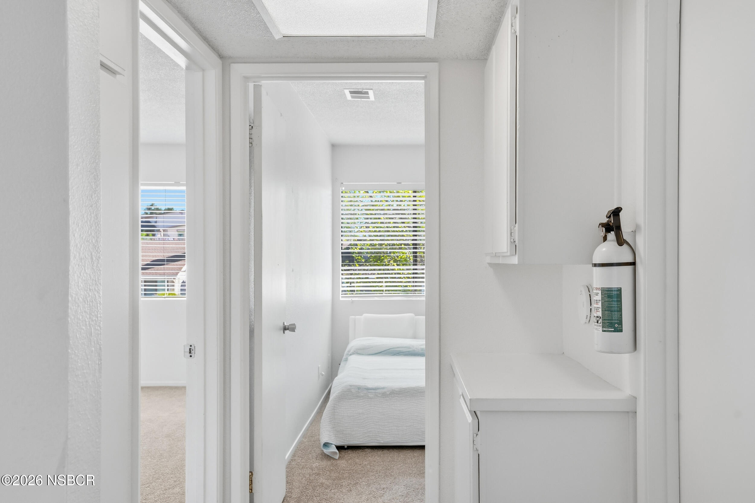 1193 East Foster Road, Unit D Santa Maria, CA 93455 - Photo 11 of 24 a view of a hallway with wooden shelves
