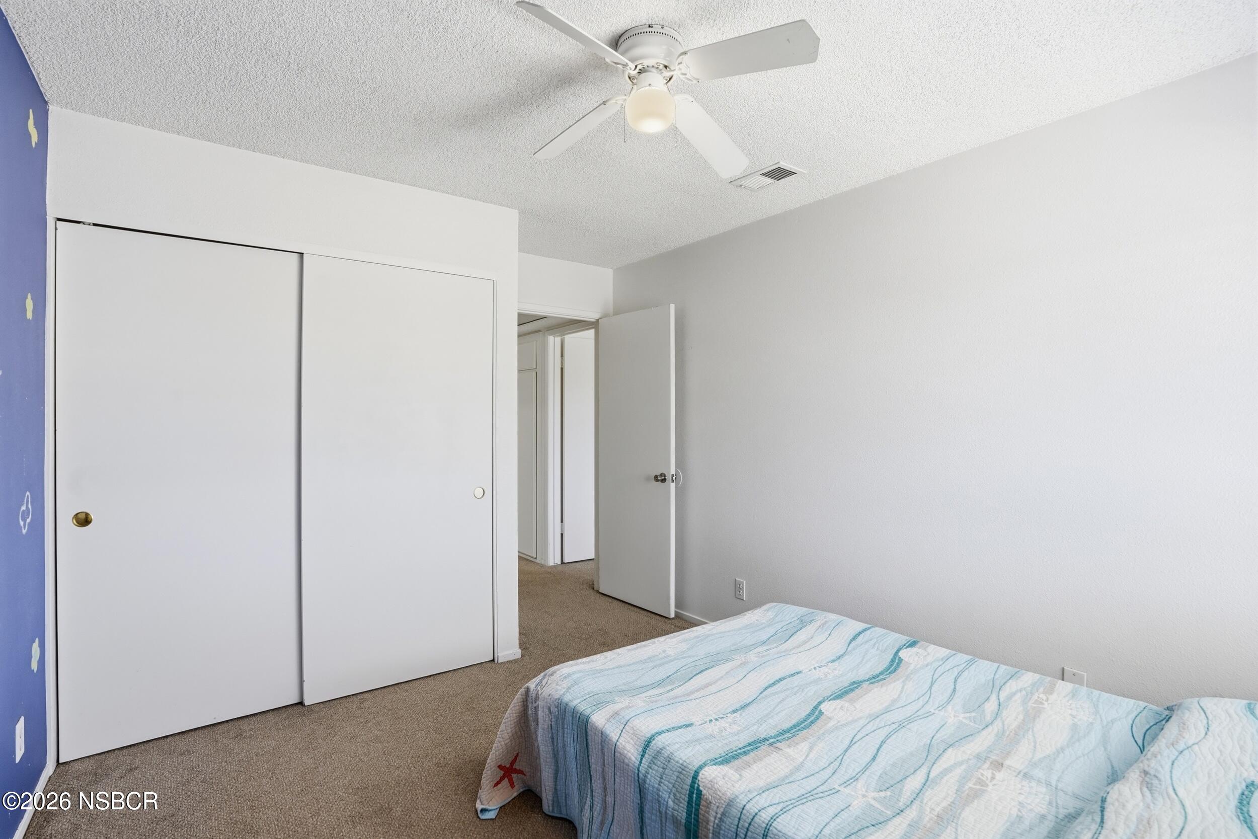 1193 East Foster Road, Unit D Santa Maria, CA 93455 - Photo 15 of 24 a bedroom with a bed and a chandelier fan
