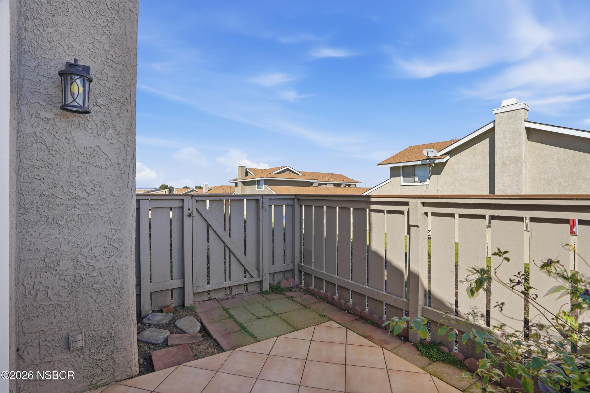 1193 East Foster Road, Unit D Santa Maria, CA 93455 - Photo 20 of 24 a view of a street with wooden fence