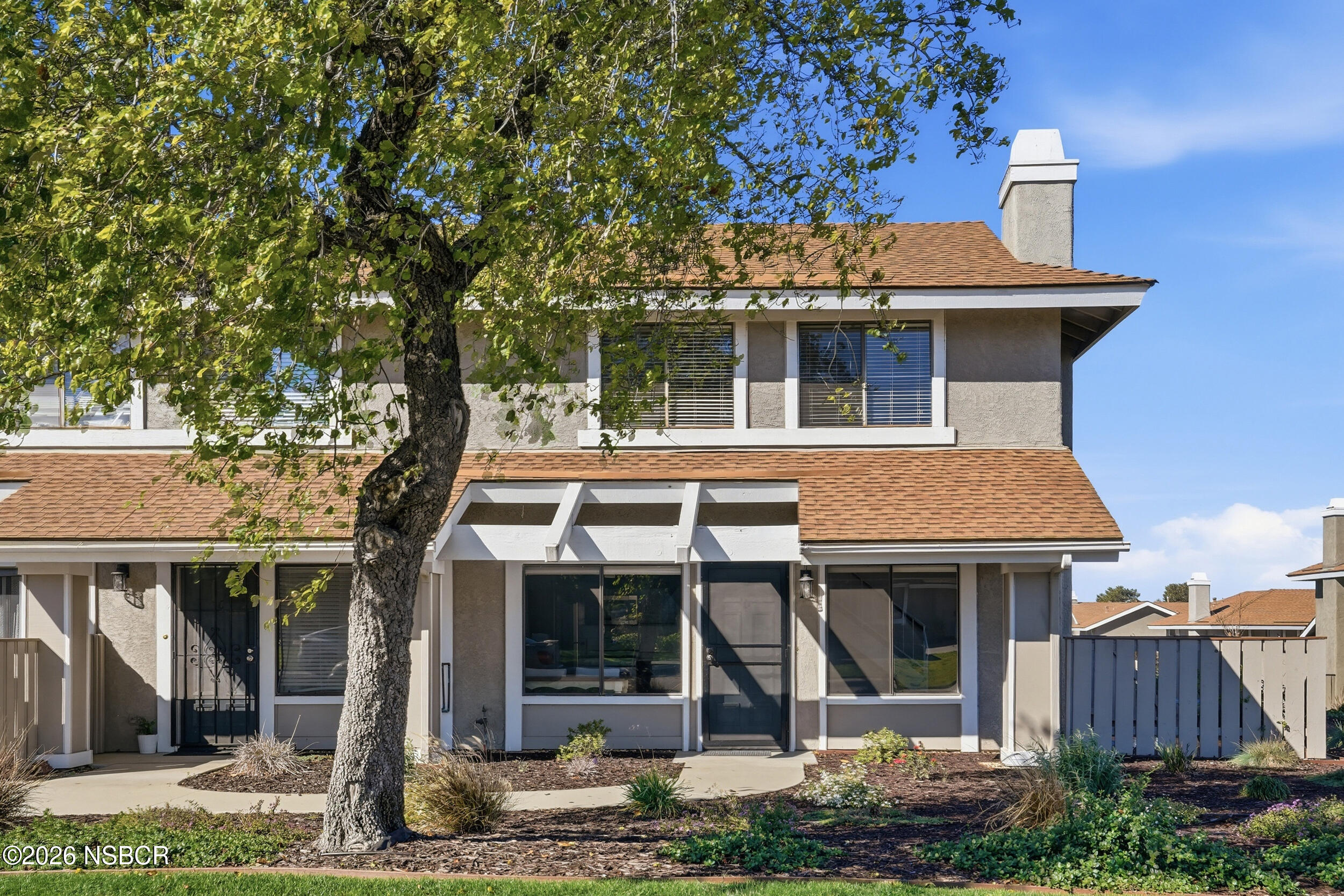 1193 East Foster Road, Unit D Santa Maria, CA 93455 - Photo 2 of 24 a front view of a house with garden