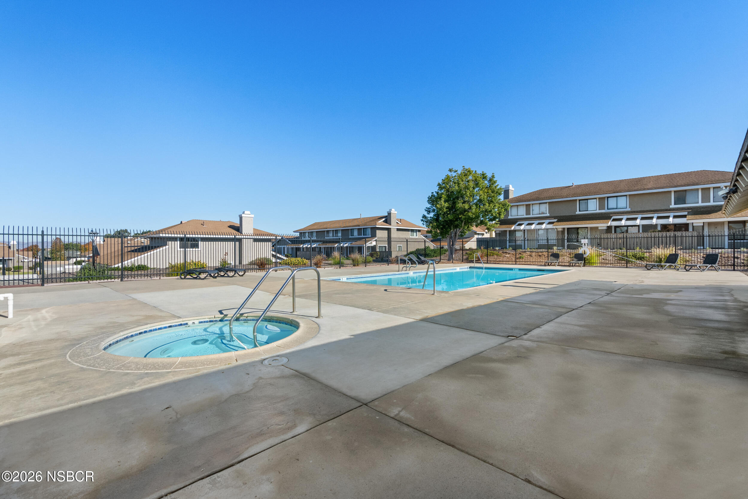 1193 East Foster Road, Unit D Santa Maria, CA 93455 - Photo 23 of 24 a view of a swimming pool with a lawn chairs and a fire pit