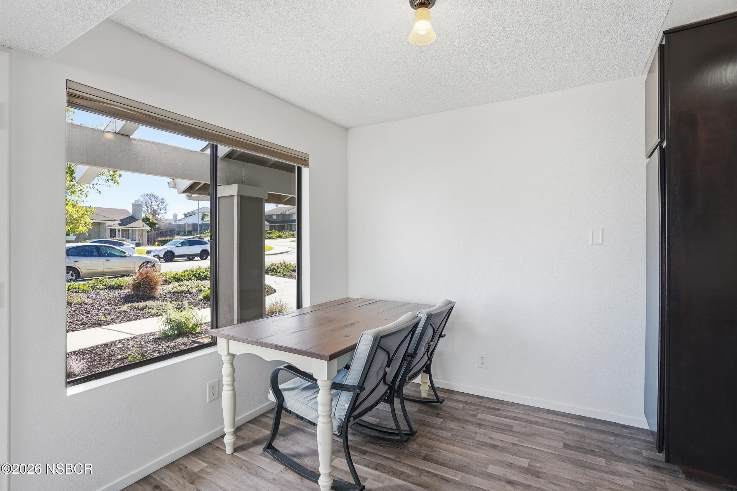 1193 East Foster Road, Unit D Santa Maria, CA 93455 - Photo 9 of 24 a view of a dining room with furniture window and wooden floor