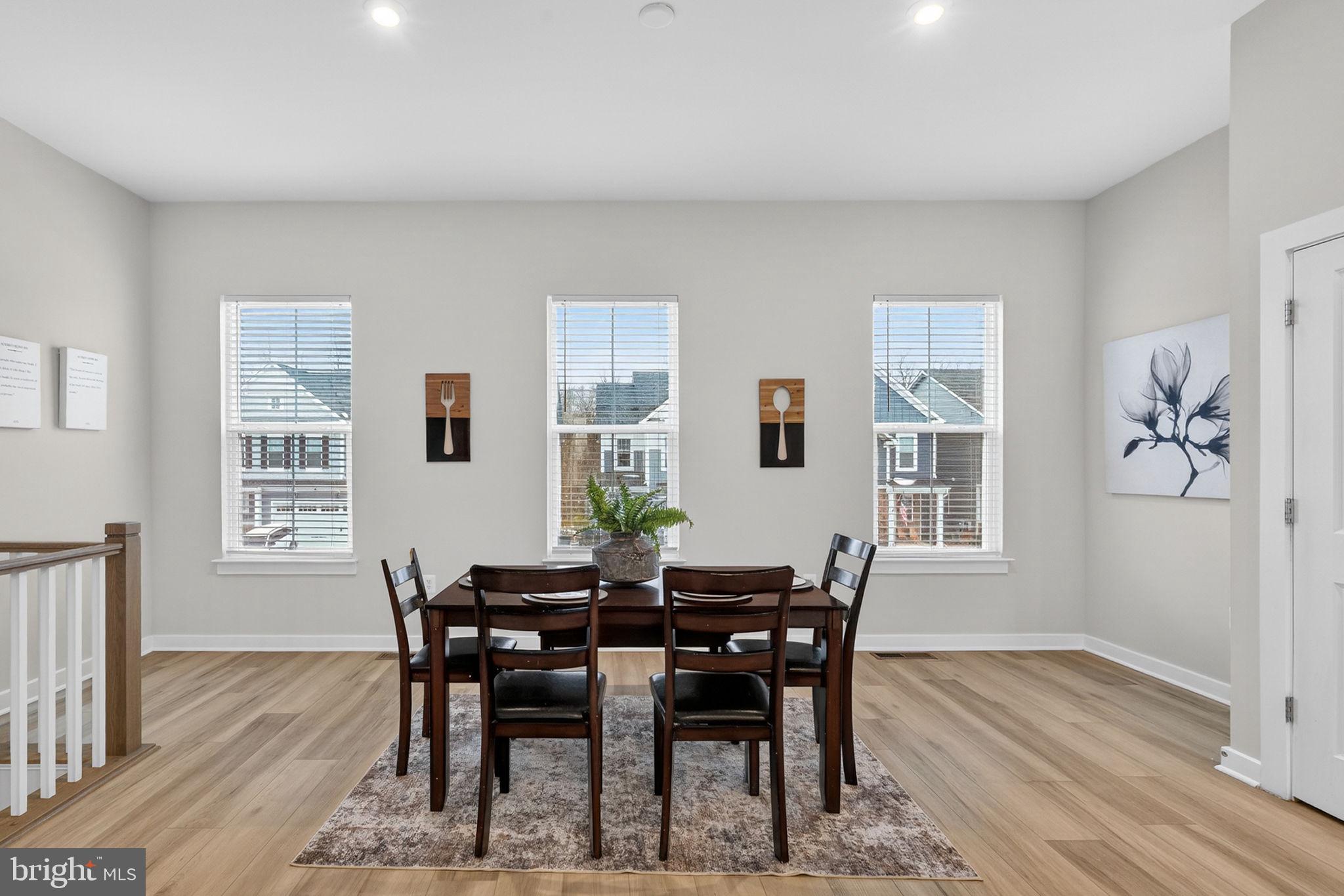 18245 Moss Garden Road Dumfries, VA 22026 - Photo 12 of 71 a view of a dining room with furniture and wooden floor