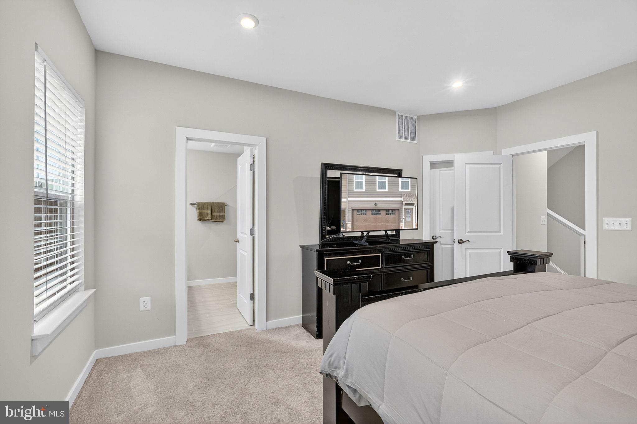 18245 Moss Garden Road Dumfries, VA 22026 - Photo 17 of 71 a bedroom with a bed and a dresser