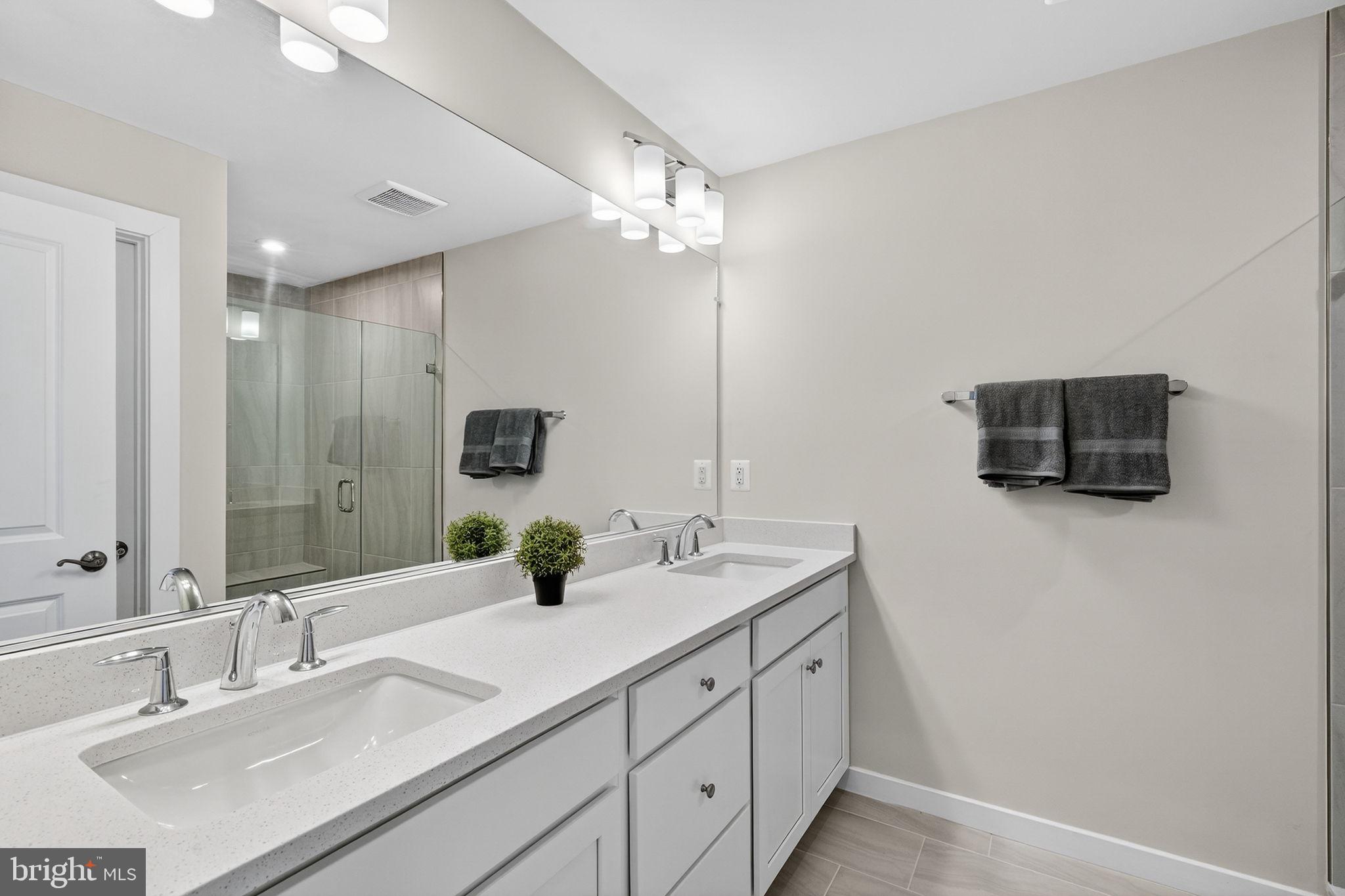 18245 Moss Garden Road Dumfries, VA 22026 - Photo 19 of 71 a bathroom with a double vanity sink and mirror