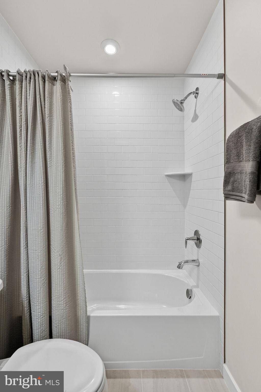 18245 Moss Garden Road Dumfries, VA 22026 - Photo 23 of 71 a bathroom with a shower a toilet and a sink
