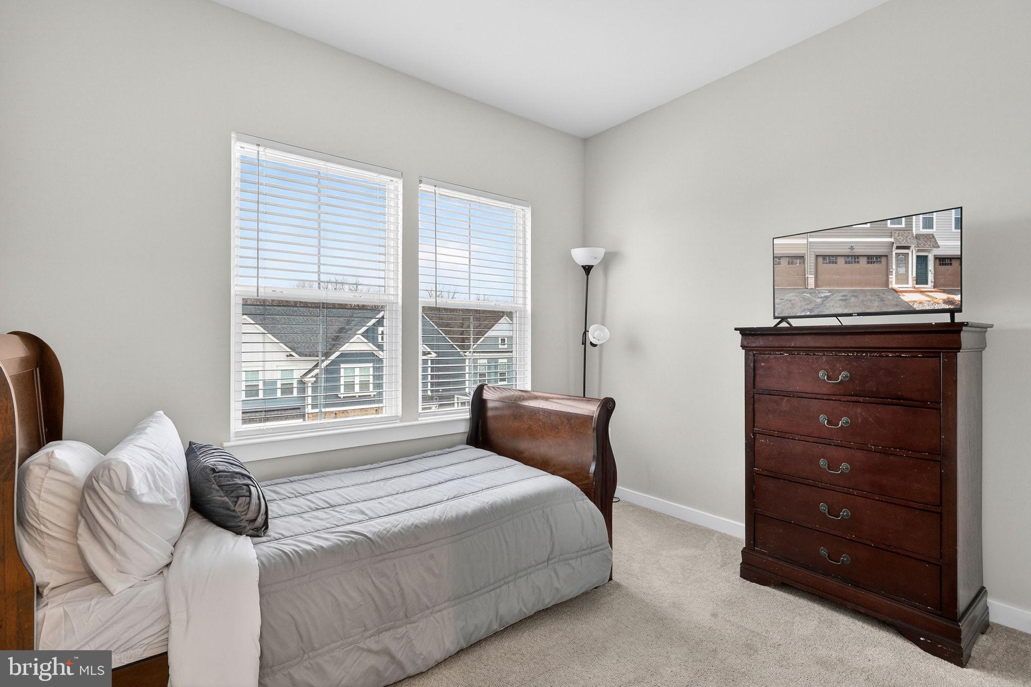 18245 Moss Garden Road Dumfries, VA 22026 - Photo 24 of 71 a bedroom with a bed and a window