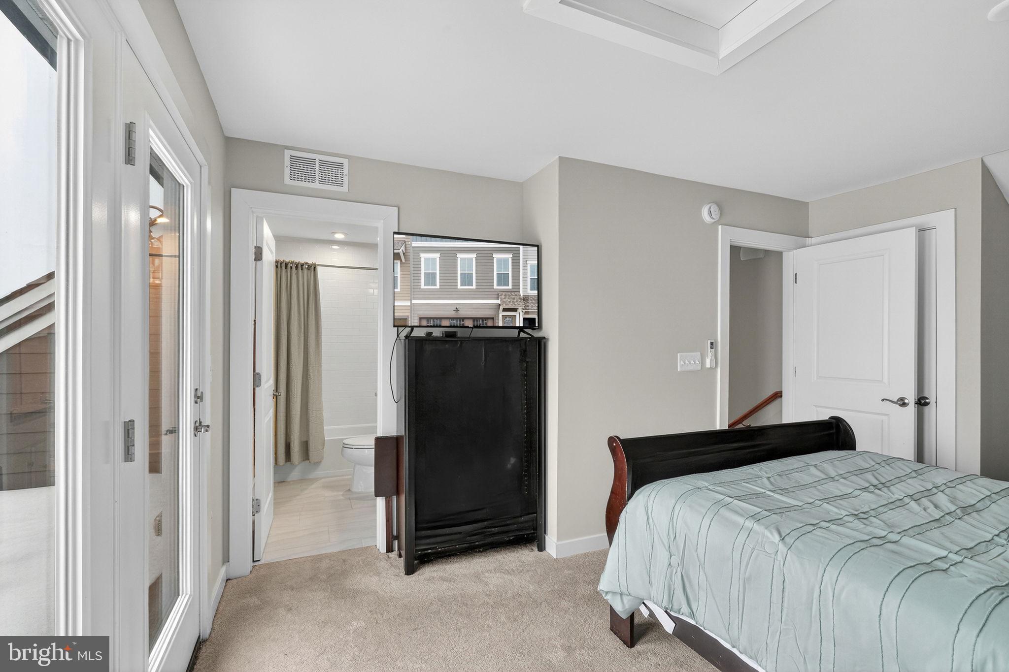 18245 Moss Garden Road Dumfries, VA 22026 - Photo 29 of 71 a bedroom with a bed and a mirror