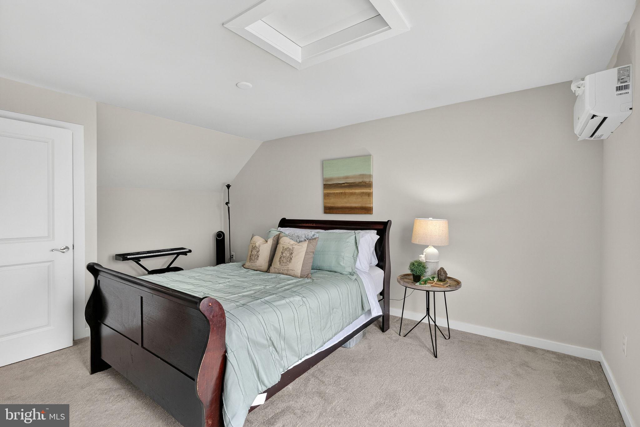 18245 Moss Garden Road Dumfries, VA 22026 - Photo 30 of 71 a bedroom with a bed and a table