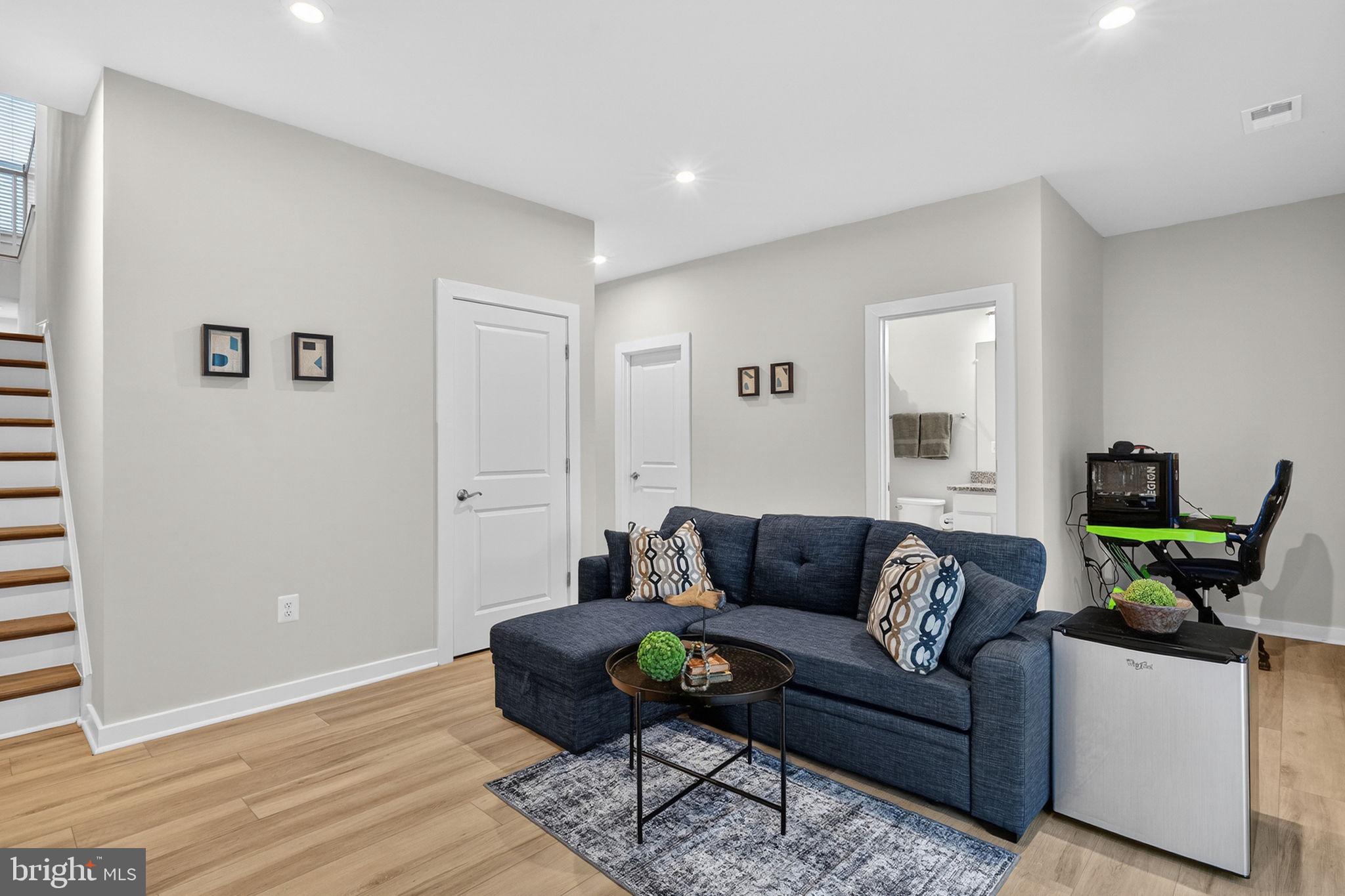 18245 Moss Garden Road Dumfries, VA 22026 - Photo 3 of 71 a living room with furniture and a wooden floor