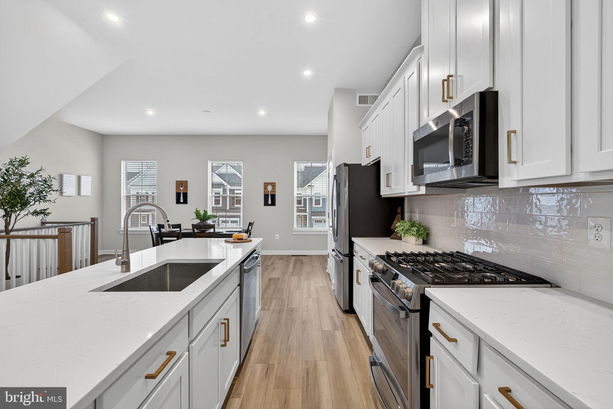 18245 Moss Garden Road Dumfries, VA 22026 - Photo 8 of 71 a kitchen with stainless steel appliances granite countertop a sink stove and refrigerator