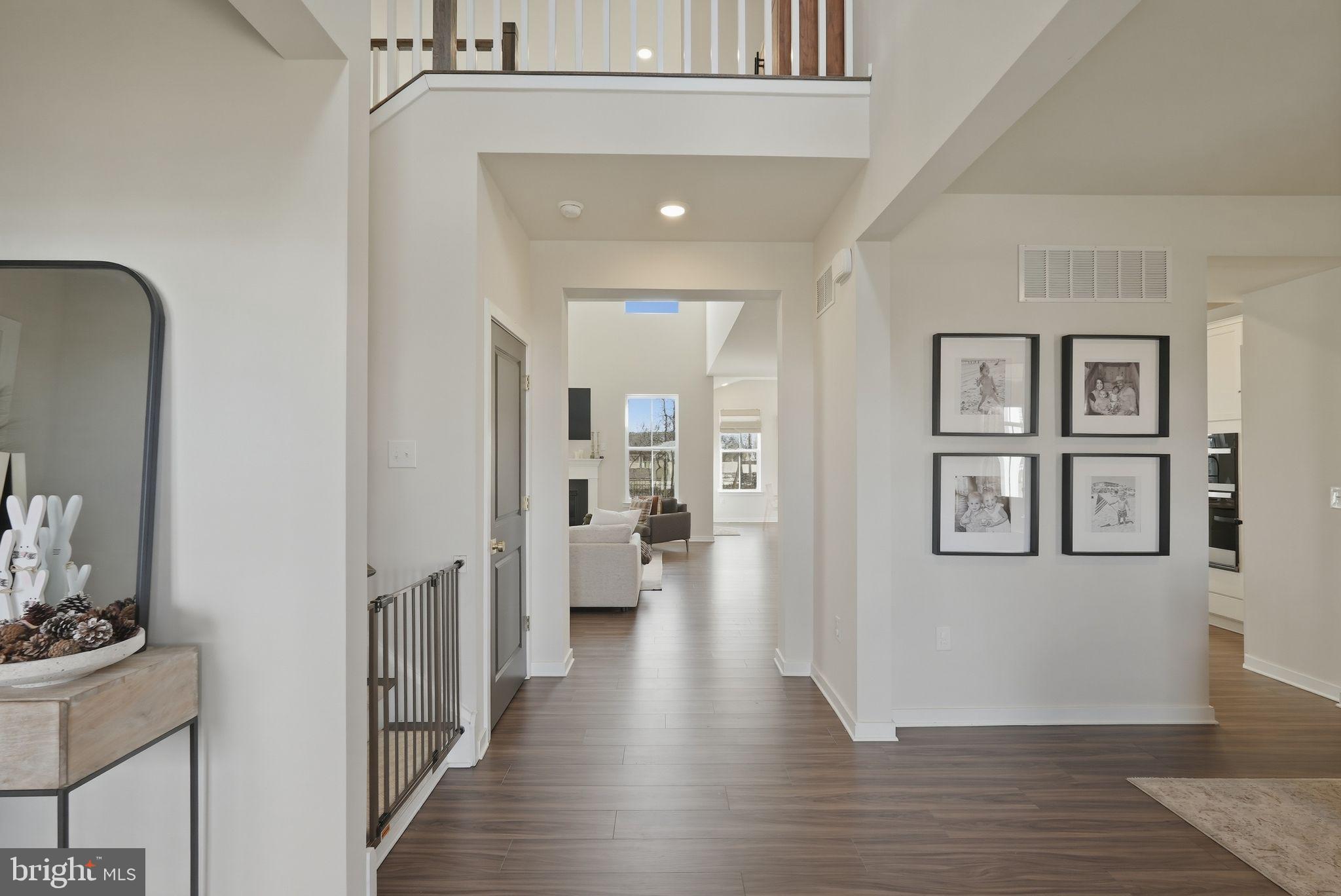 1017 Mariwill Drive Quakertown, PA 18951 - Photo 3 of 31 a view of a hallway with wooden floor and a living room