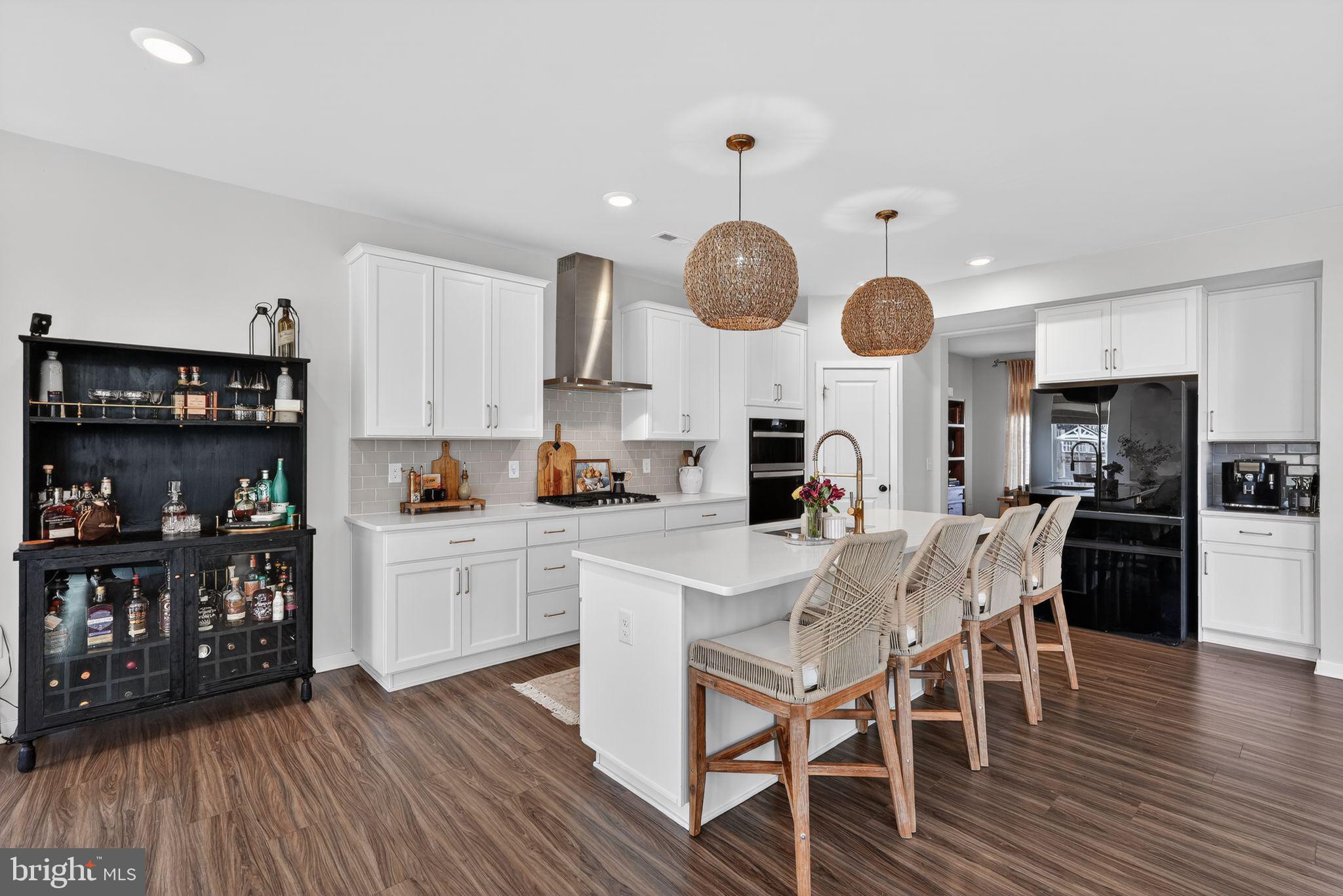 1017 Mariwill Drive Quakertown, PA 18951 - Photo 7 of 31 a kitchen with stainless steel appliances a dining table chairs and wooden floor
