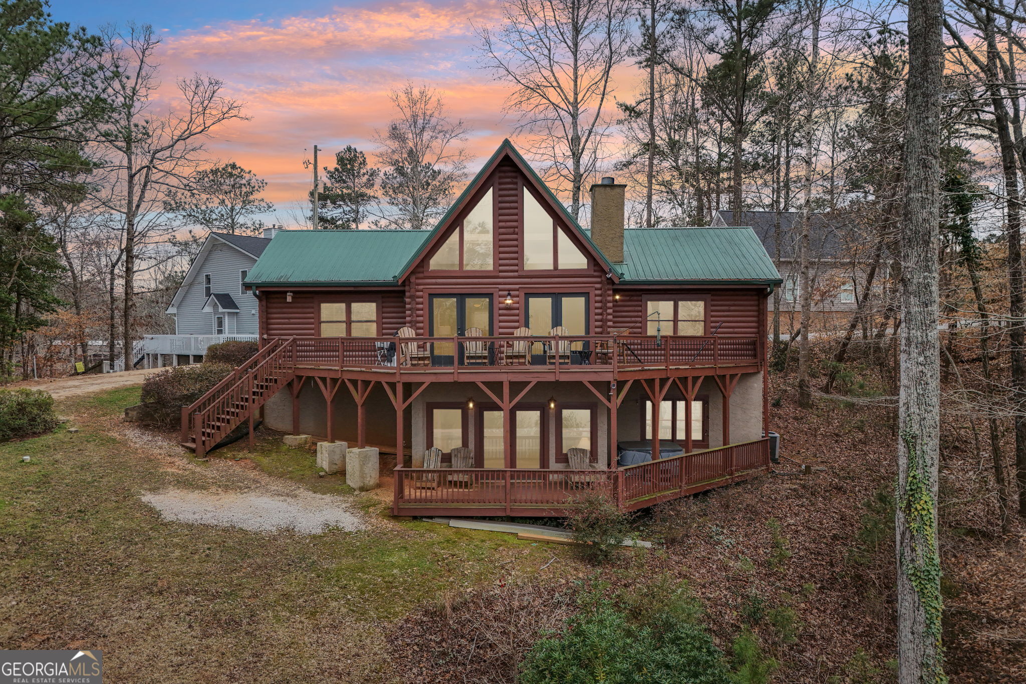 a view of a house with a yard and deck area
