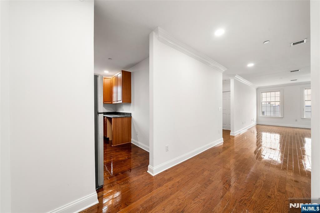 180 Edgewater Road, Unit 1A Cliffside Park, NJ 07010 - Photo 12 of 30 a view of a hallway with wooden floor and a bathroom