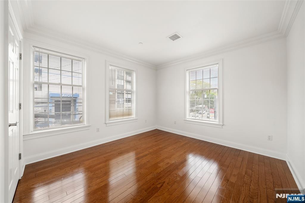 180 Edgewater Road, Unit 1A Cliffside Park, NJ 07010 - Photo 16 of 30 a view of an empty room with a window and wooden floor