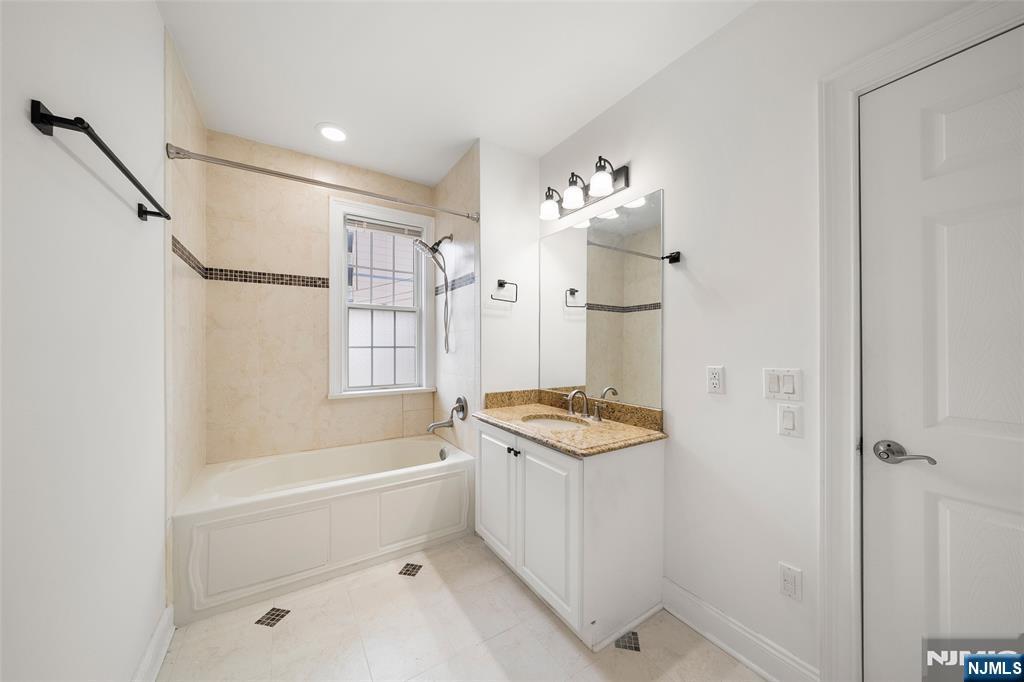 180 Edgewater Road, Unit 1A Cliffside Park, NJ 07010 - Photo 18 of 30 a bathroom with a sink a toilet and shower