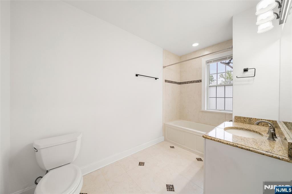 180 Edgewater Road, Unit 1A Cliffside Park, NJ 07010 - Photo 19 of 30 a bathroom with a sink and toilet