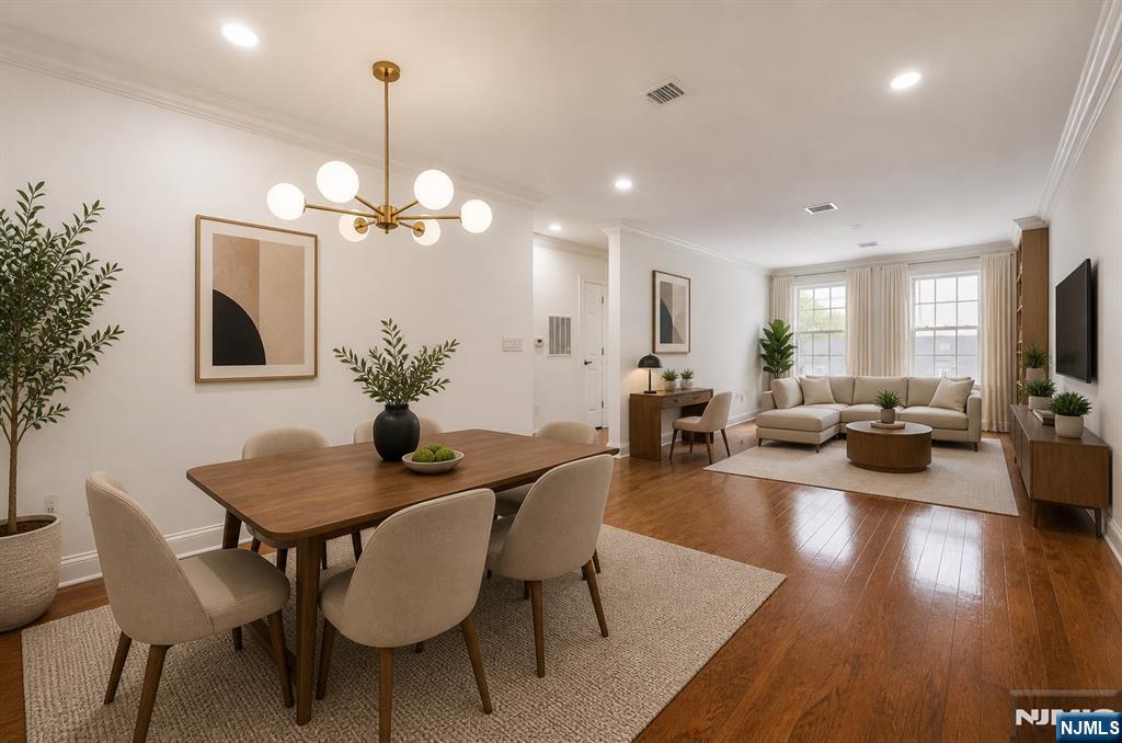 180 Edgewater Road, Unit 1A Cliffside Park, NJ 07010 - Photo 6 of 30 a view of a dining room with furniture wooden floor and chandelier