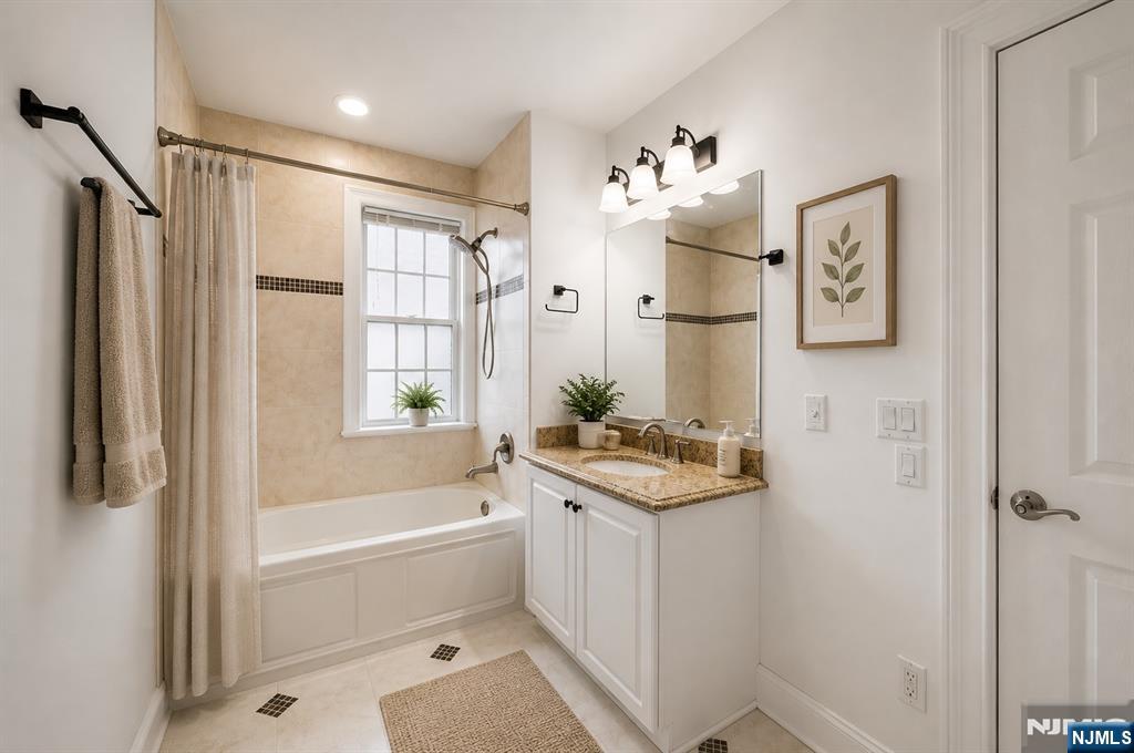 180 Edgewater Road, Unit 1A Cliffside Park, NJ 07010 - Photo 7 of 30 a bathroom with a bathtub sink and mirror