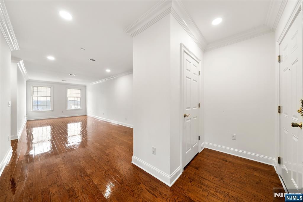 180 Edgewater Road, Unit 1A Cliffside Park, NJ 07010 - Photo 8 of 30 a view of empty room with wooden floor and fan