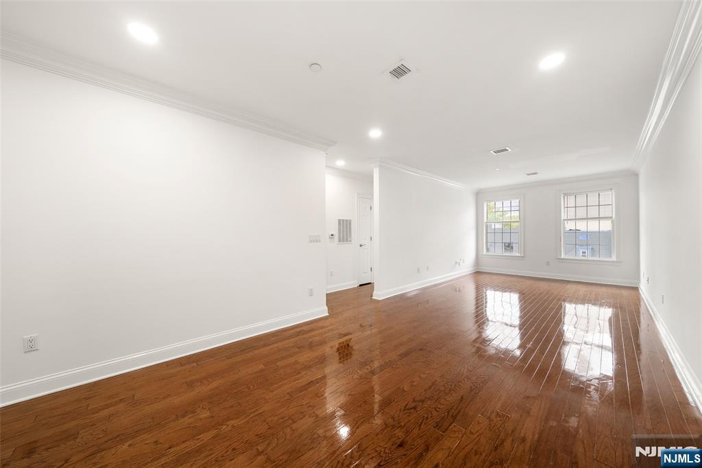 180 Edgewater Road, Unit 1A Cliffside Park, NJ 07010 - Photo 10 of 30 a view of empty room with wooden floor and fan