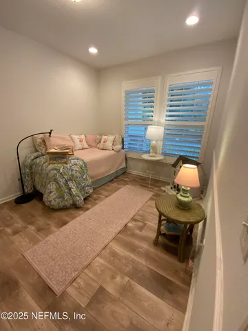 a bedroom with furniture and a window