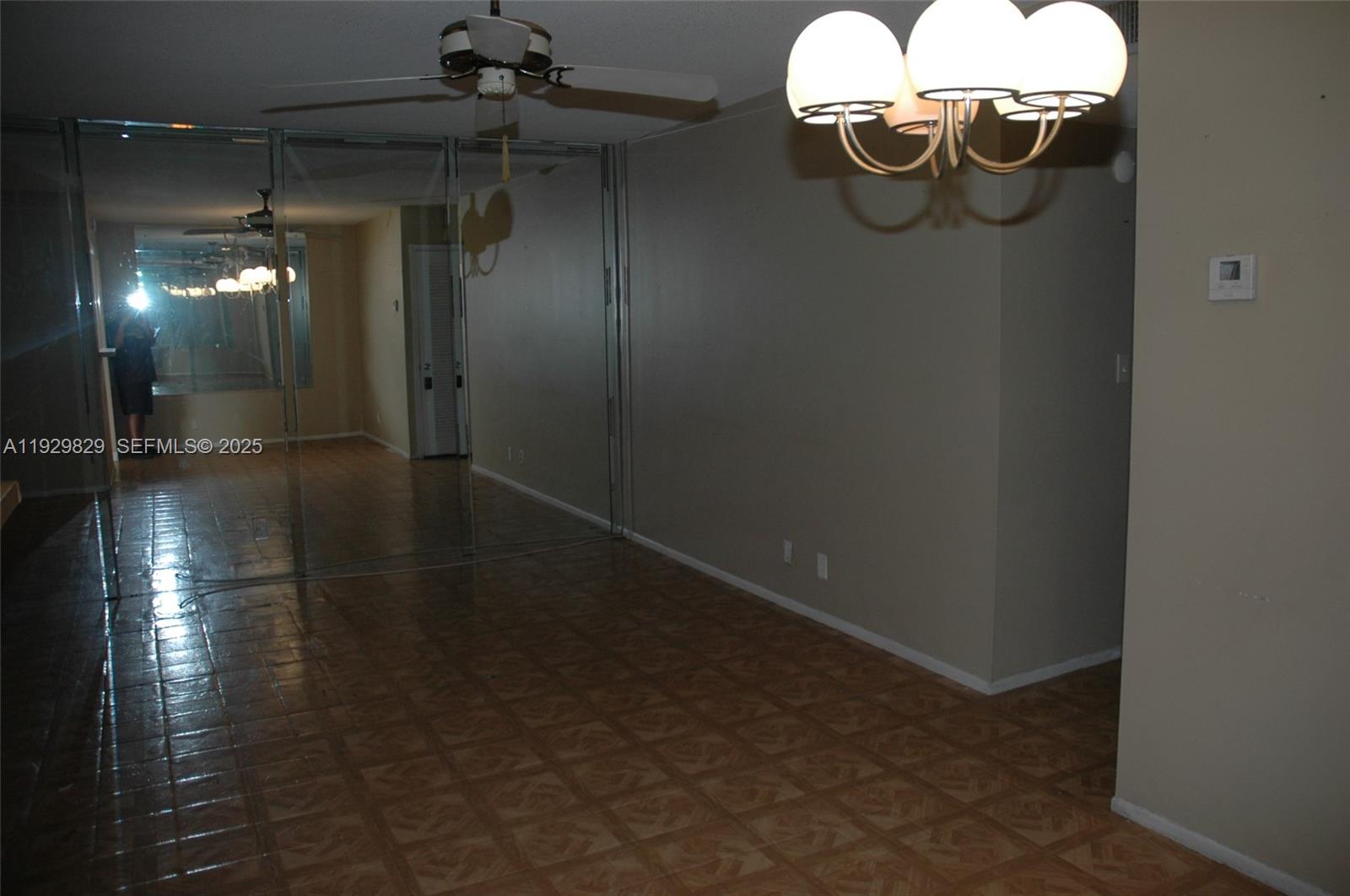 5300 Washington Street, Unit F119 Hollywood, FL 33021 - Photo 12 of 24 a room with lots of chandelier fan and glass door