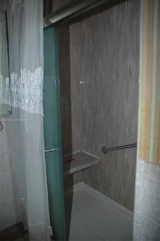 a view of a livingroom with an empty space and a window