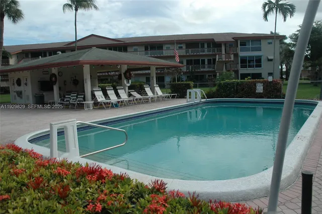 a front view of a house with a garden and trees