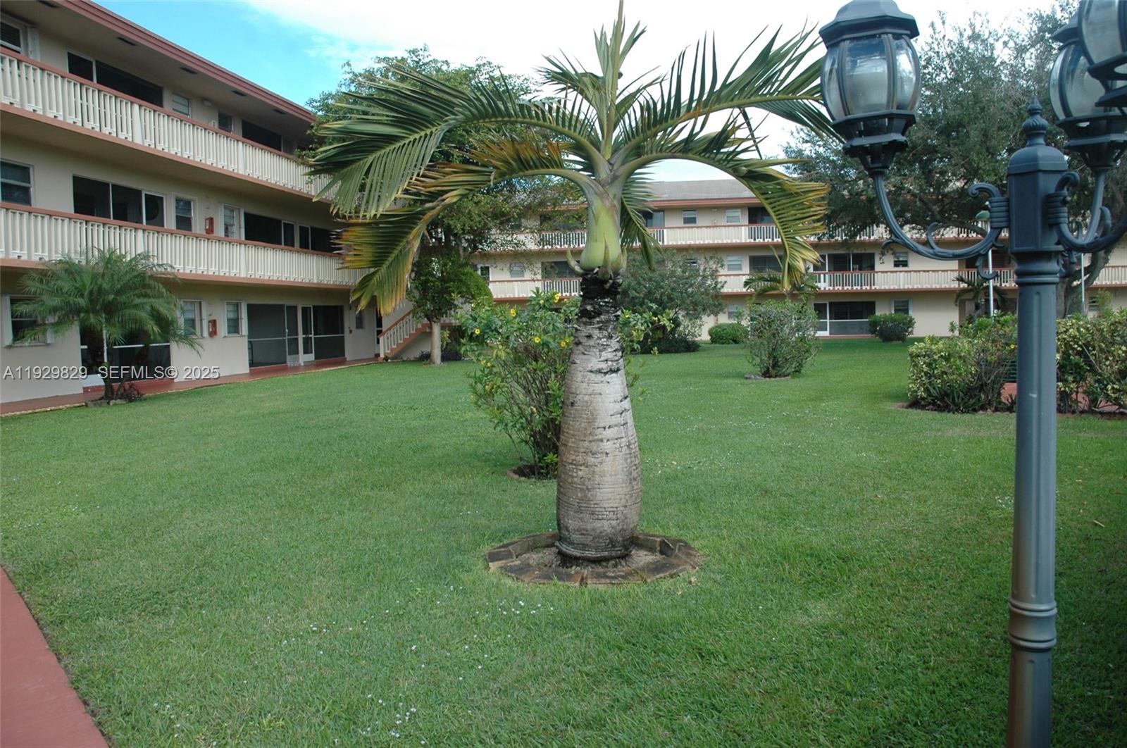 5300 Washington Street, Unit F119 Hollywood, FL 33021 - Photo 7 of 24 a front view of a house with a garden and trees