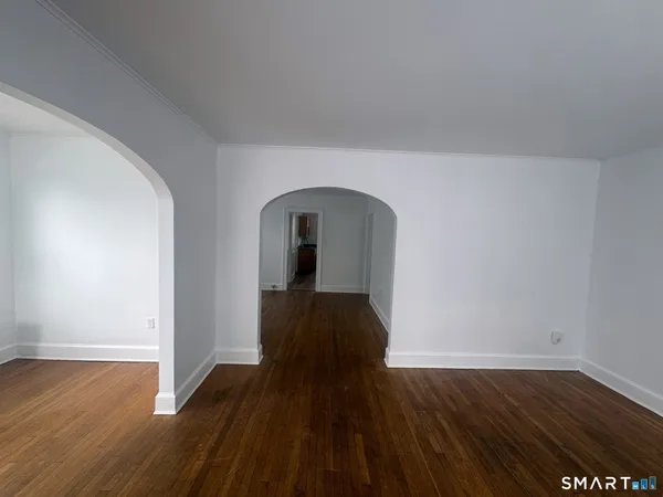 a view of a living room with wooden floor