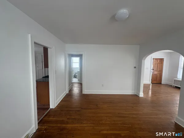 a view of a hallway with wooden floor