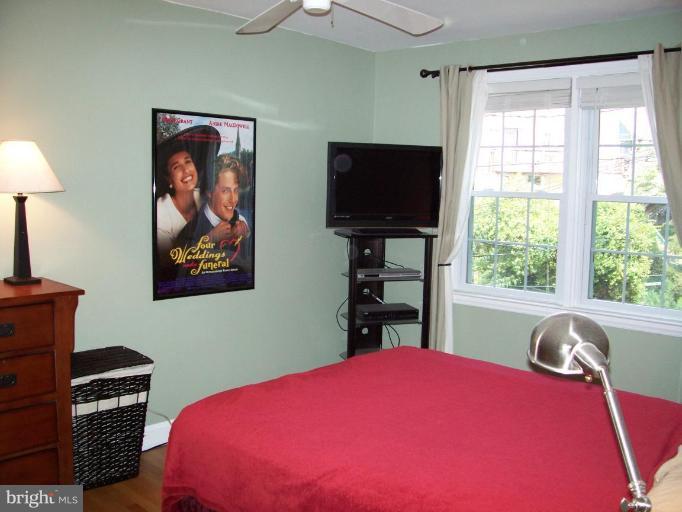 156 Dumbarton Road Baltimore, MD 21212 - Photo 11 of 14 a bedroom with a bed and a flat screen tv