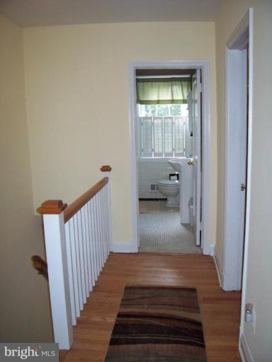 156 Dumbarton Road Baltimore, MD 21212 - Photo 13 of 14 a view of a hallway view with wooden floor and a bathroom