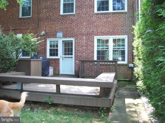 156 Dumbarton Road Baltimore, MD 21212 - Photo 8 of 14 a wooden bench sitting in front of a building