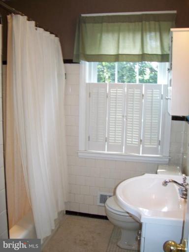 156 Dumbarton Road Baltimore, MD 21212 - Photo 10 of 14 a bathroom with a sink toilet and window