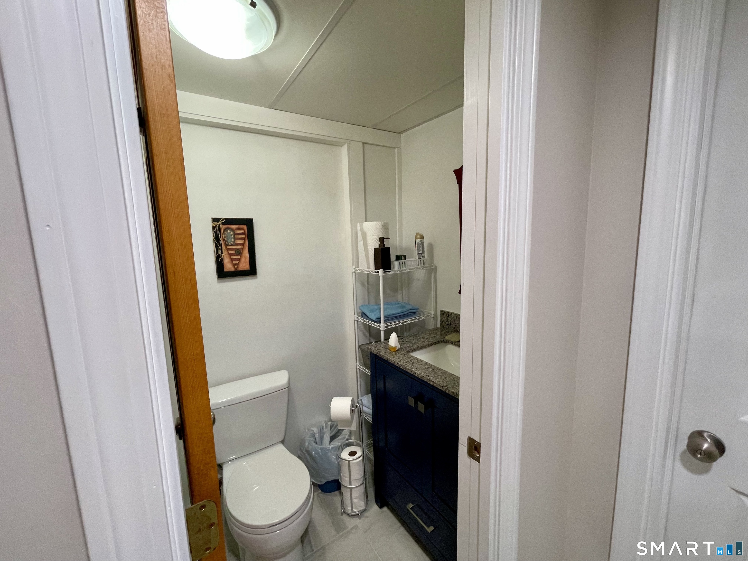 203 Pine Hollow Road Killingly, CT 06241 - Photo 8 of 14 a bathroom with a granite countertop toilet and a sink