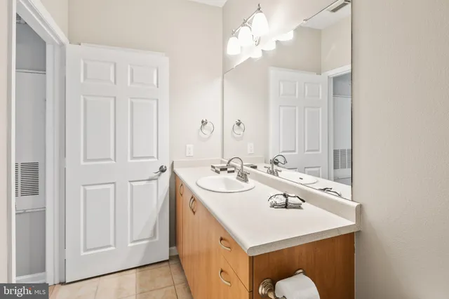 a bathroom with a sink a mirror and a vanity