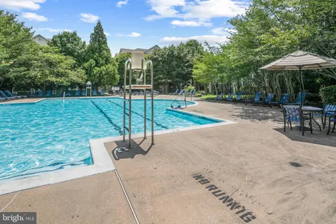 a view of a backyard with swimming pool