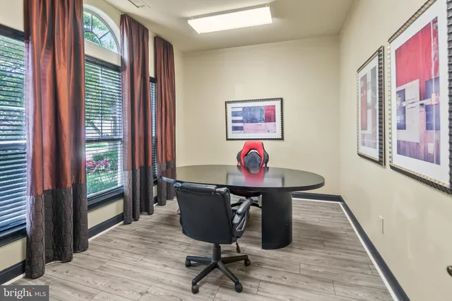 a view of a workspace with furniture and a window