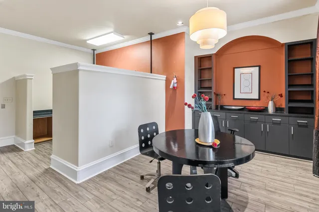 a kitchen with a sink cabinets and dining table