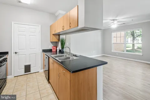 a kitchen with stainless steel appliances granite countertop a sink and a stove