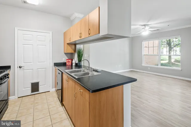 a kitchen with stainless steel appliances granite countertop a sink and a stove