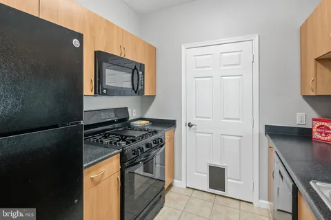 a kitchen with stainless steel appliances granite countertop a stove and a refrigerator