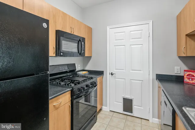 a kitchen with stainless steel appliances granite countertop a stove and a refrigerator